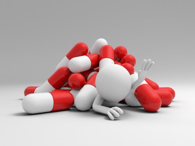 Cartoon person under pile of pills